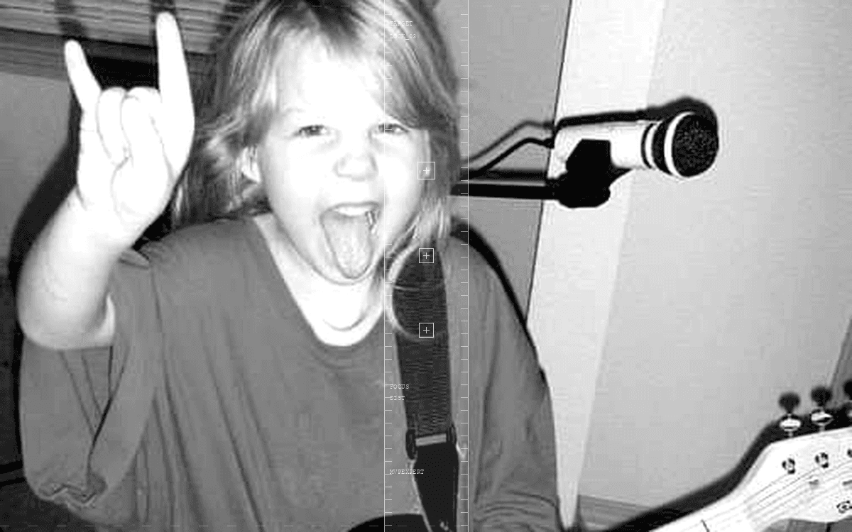 Monochrome kid with guitar — passion projects portrait with tech HUD overlay